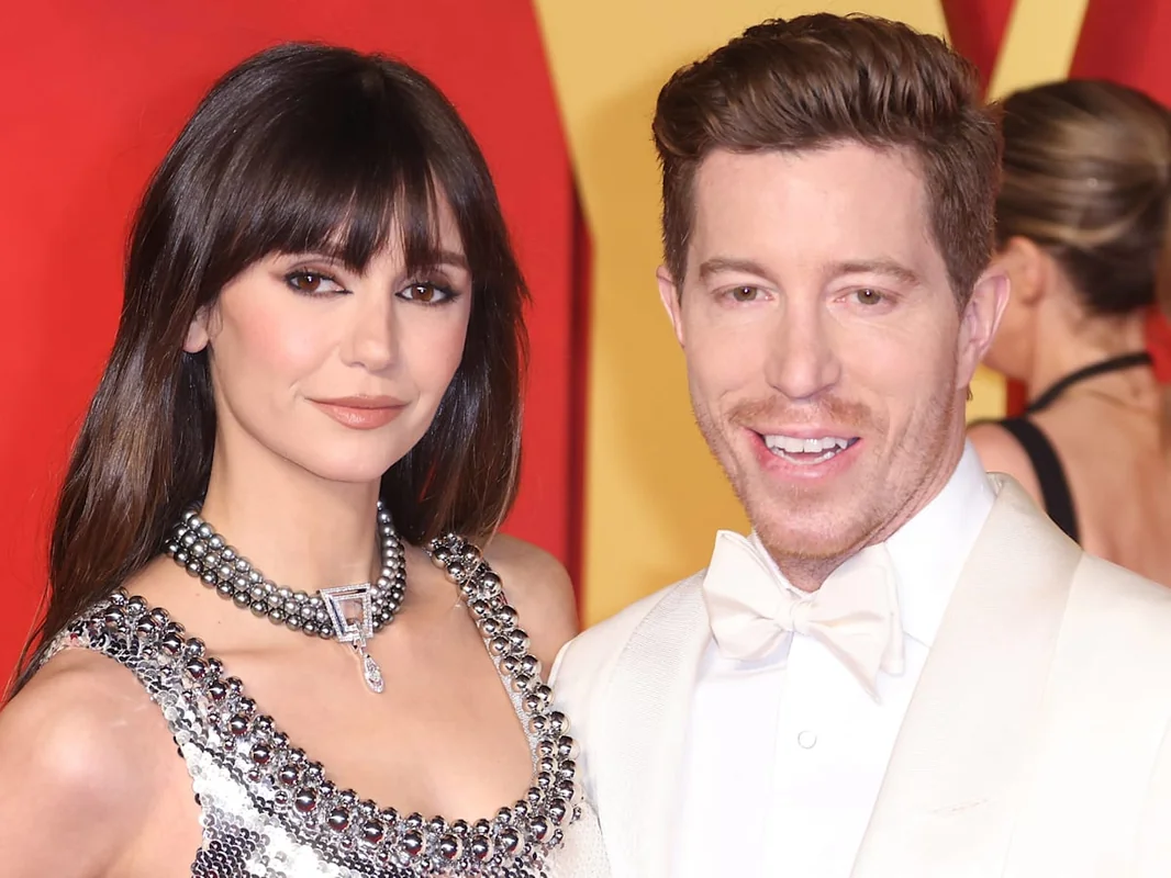 Nina Dobrev engagement ring with fiancé at an event.