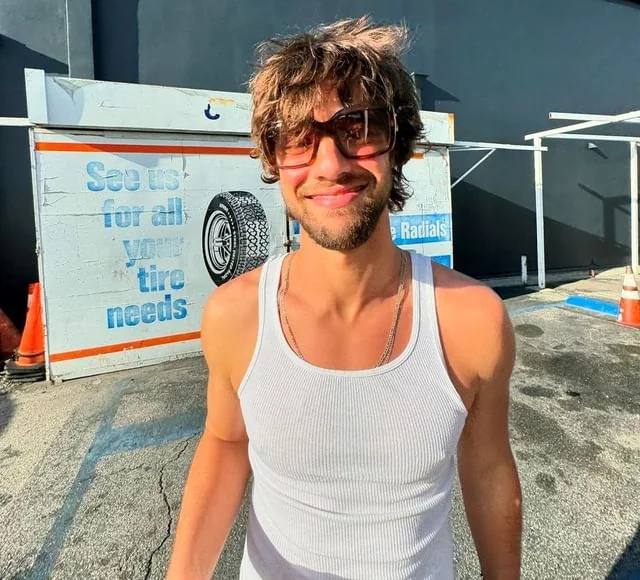 Cameron Dallas smiling casually, relevant to his net worth.