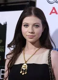 Michelle Trachtenberg in a stylish outfit with a necklace