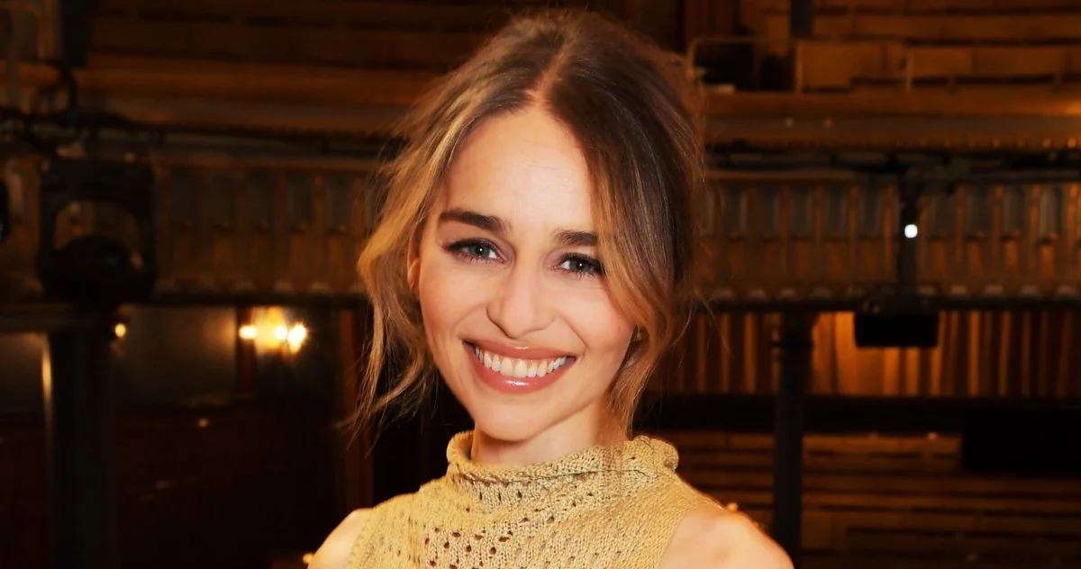 Emilia Clarke smiling at a public event, reflecting her positive outlook through recovery