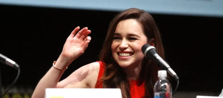 Emilia Clarke smiling at a public event, showcasing her career.