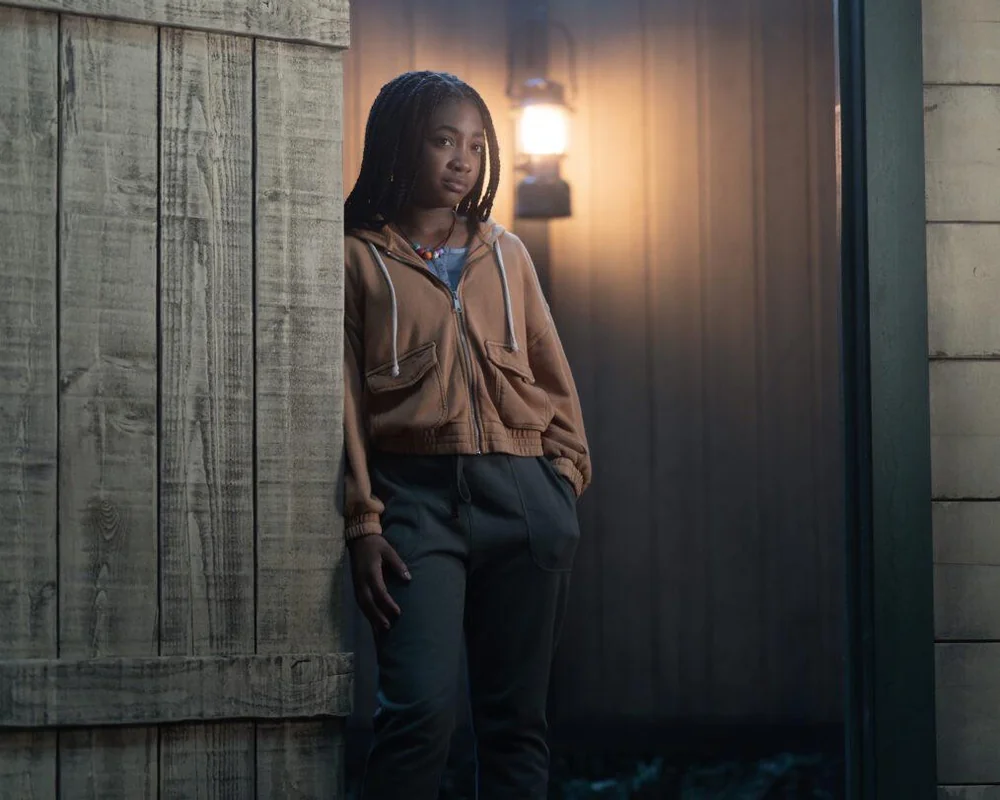 Leah Sava Jeffries standing thoughtfully in a scene, embodying her character's depth.