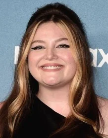 Megan Stalter smiling confidently at an event, highlighting her success in the entertainment industry.