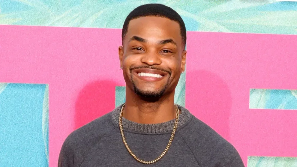 King Bach poses confidently at a promotional event, showcasing his style and relevance to his age.
