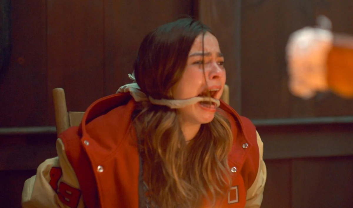 Addison Rae on a red carpet in a sleek monochrome gown