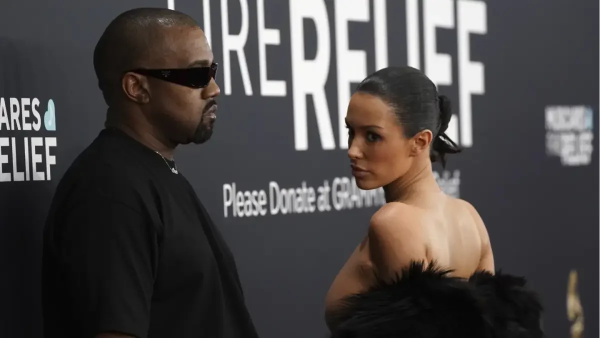 Kanye West and Bianca Censori share a tense moment amid divorce rumors.