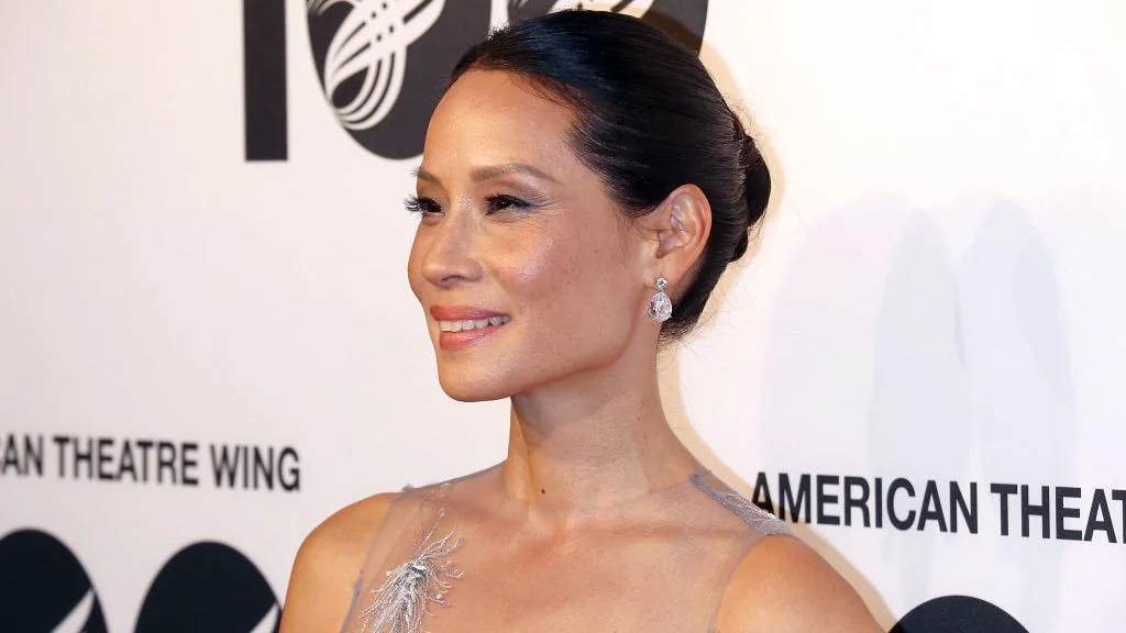 Lucy Liu in a silver gown at a prestigious event.
