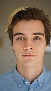 Another professional headshot showcasing an actor's features.