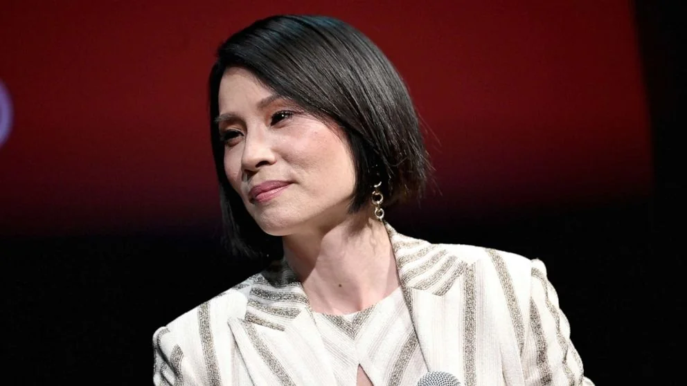 Lucy Liu speaking at a panel discussion.