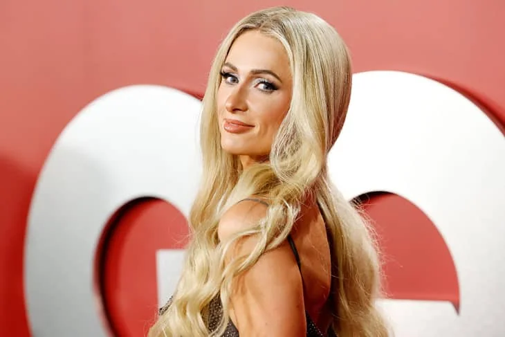 Paris Hilton at an event, representing her brand.