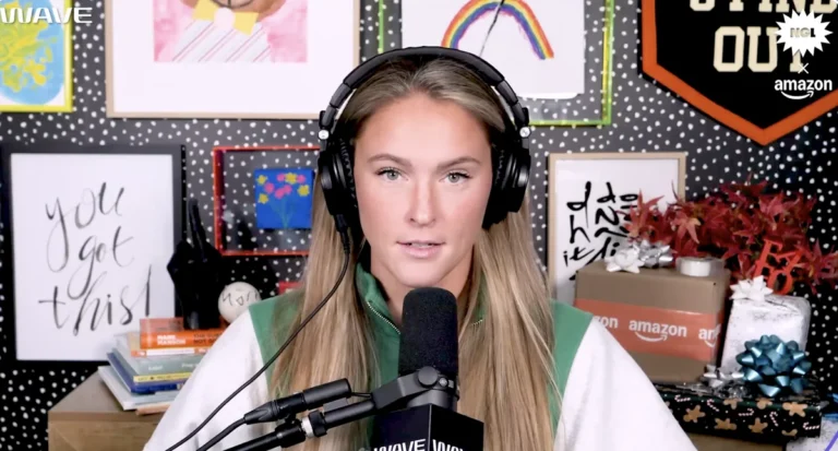 Kylie Kelce engaged in her Olympics gig, speaking into a microphone.