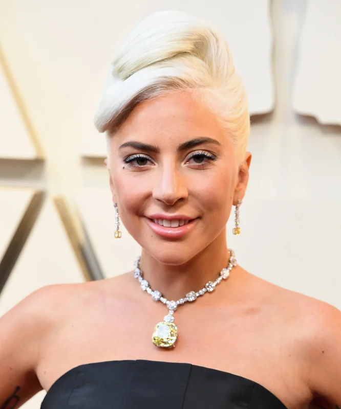 Lady Gaga ring showcased in a glamorous necklace at an event.