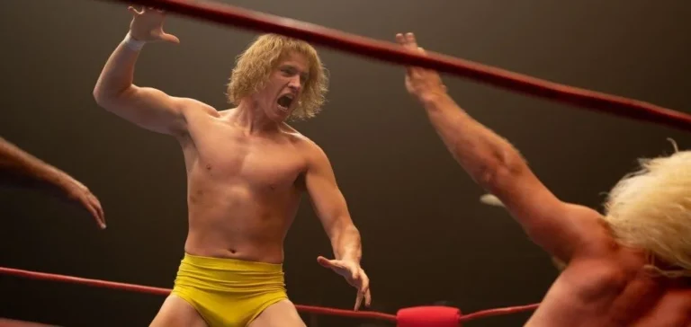 Zac Efron filmer wrestling scene with intense action.