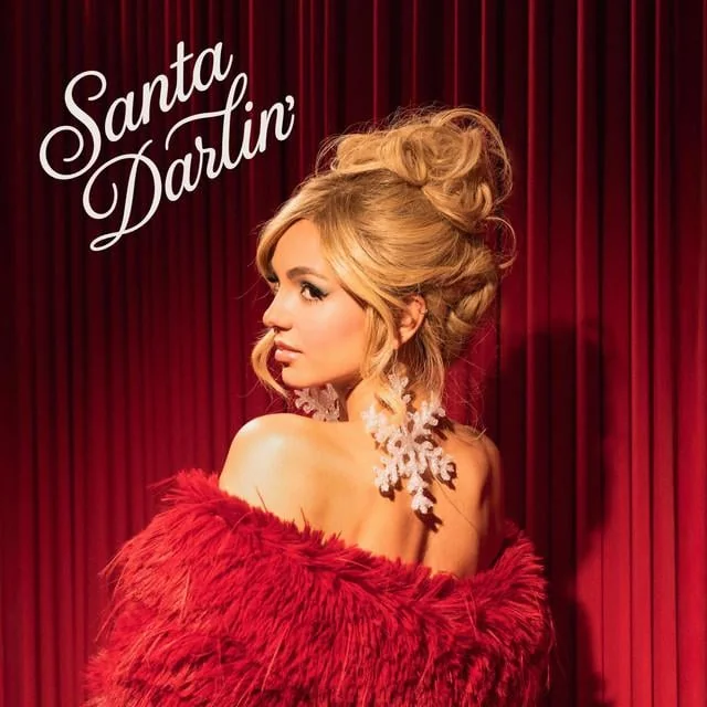 Victoria Justice in a red fur coat for Santa Darlin theme.