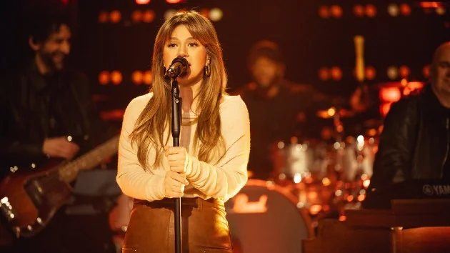 Kelly Clarkson performing live, showcasing her powerful songs.