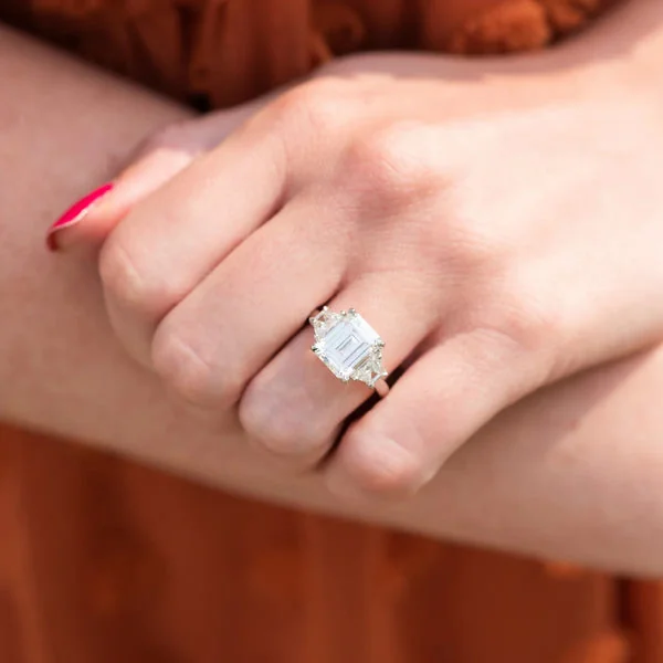 Close-up of Demi Lovato engagement ring highlighting a pear-shaped solitaire on a slim band