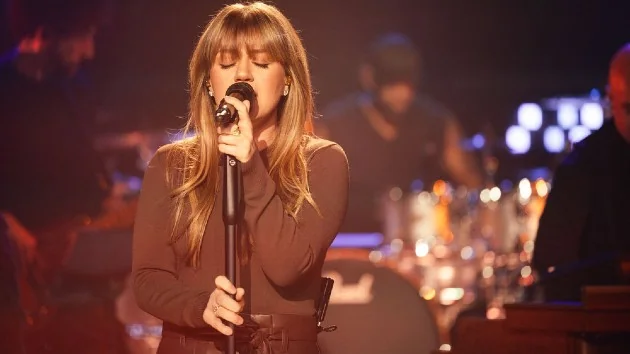 Kelly Clarkson performing with emotional depth in her songs.