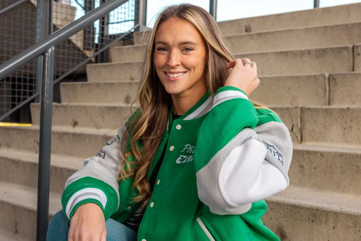 Kylie Kelce in a varsity jacket, representing her sports connection.