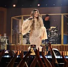 Kelly Clarkson performing live, connecting with her audience through songs.