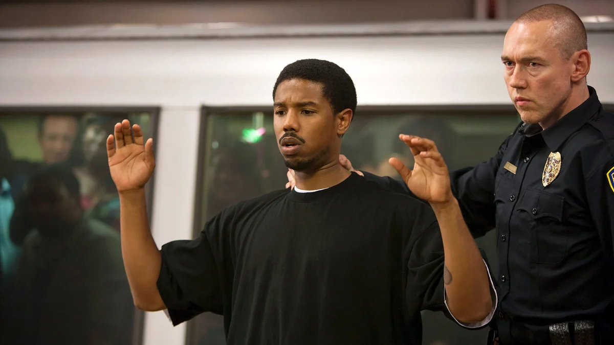 Michael B. Jordan in a tense scene with police in a movie.