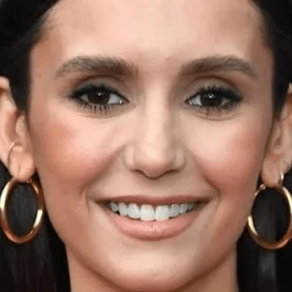 Close-up of Nina Dobrev smiling, showcasing her charm in movies.
