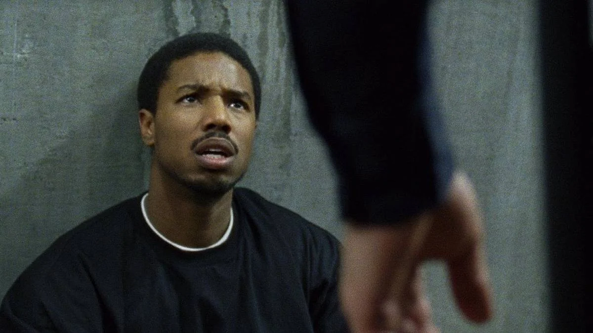 Michael B. Jordan experiencing a moment of realization in a film.